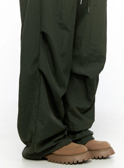 Pintuck Nylon Wide Pants CL514 Dark green close-up detail of lower leg and hem showing gathered nylon drape and chunky boot pairing