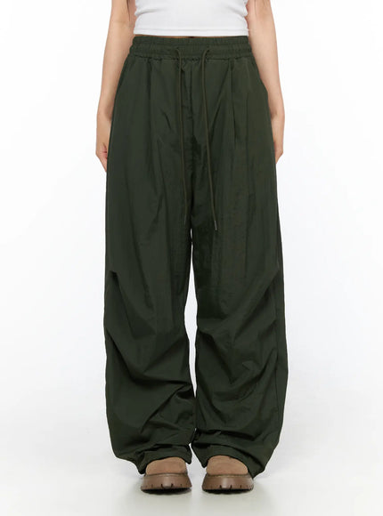 Pintuck Nylon Wide Pants CL514 Dark green front view on model standing showing elastic waistband drawstring and voluminous wide-leg nylon fabric