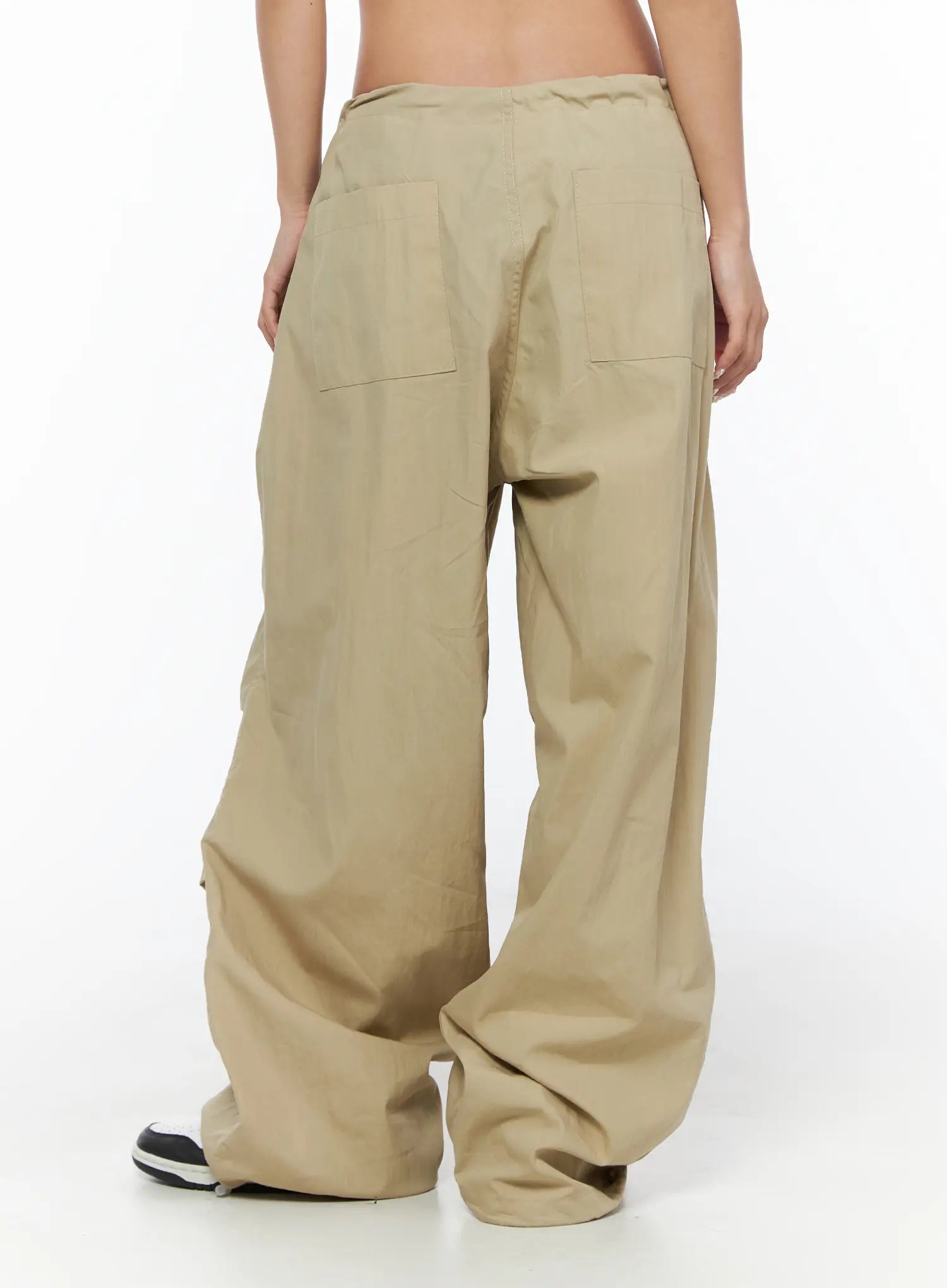 Pintuck Pocket Parachute Pants CU524 Beige back shot on model showing two large patch back pockets low rise waistband and pooling hem