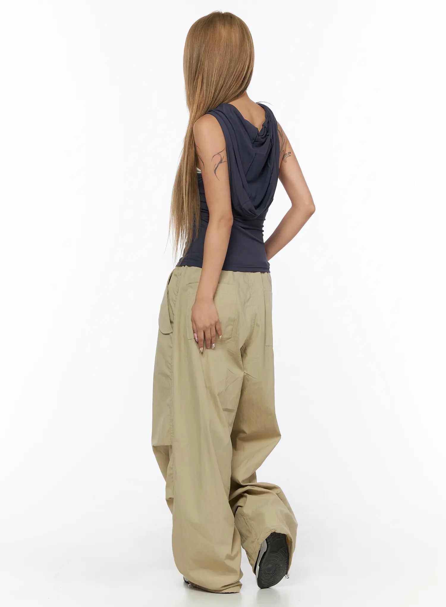 Pintuck Pocket Parachute Pants CU524 Beige back three-quarter full-body shot on model showing rear cargo pockets and oversized draped hem pooling at feet