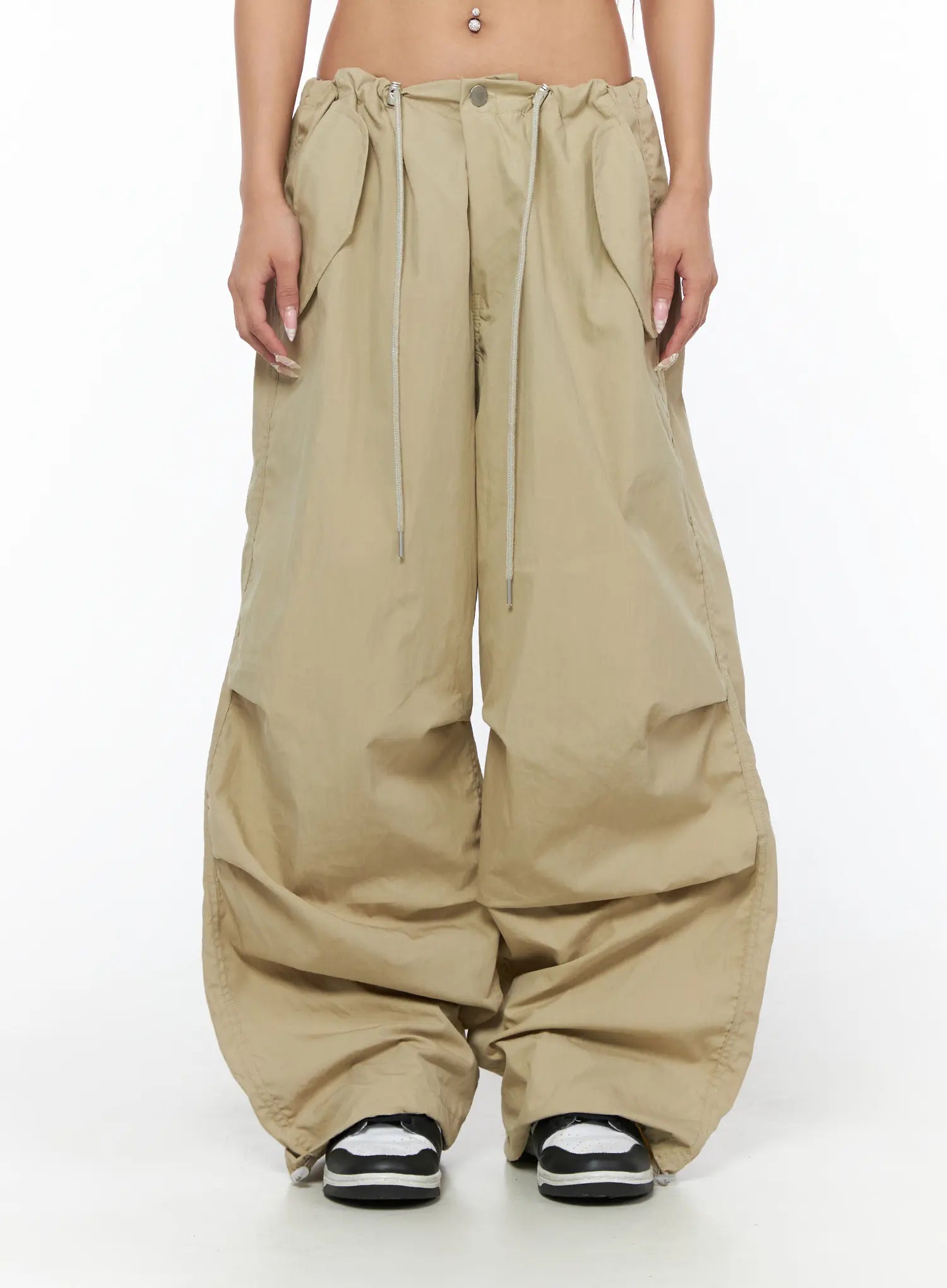 LEWKIN Pintuck Pocket Parachute Pants CU524 Beige front crop shot on model showing drawstring waistband pleats and wide-leg nylon silhouette with pooling hem