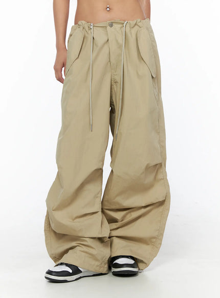 Pintuck Pocket Parachute Pants CU524 Beige front mid-body shot on model showing full waistband drawstring pockets wide balloon leg and gathered hem