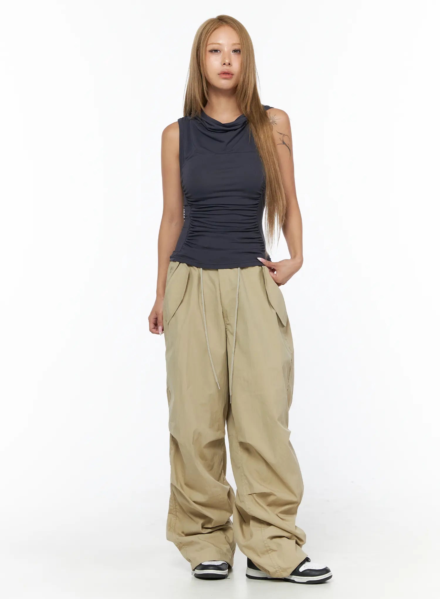 Pintuck Pocket Parachute Pants CU524 Beige full-body front shot on standing model styled with dark sleeveless top showing overall silhouette and length