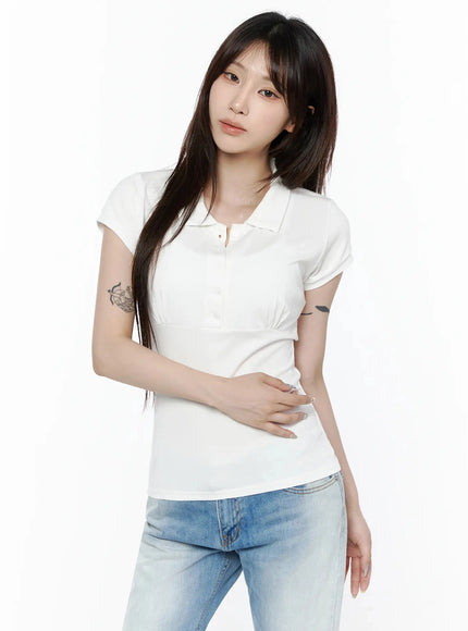 Pintuck Short Sleeve Collar Top IL502 White three-quarter front view on model hand touching collar showing bust pintuck and button detail