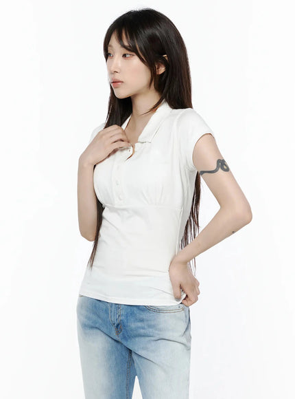 Pintuck Short Sleeve Collar Top IL502 White side view on model hand touching collar looking left showing slim waist and cap sleeve