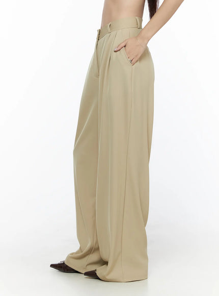 Pintuck Wide Leg Pants (Beige) CL524 Beige side shot on model with hand in pocket highlighting wide-leg drape and belt loops