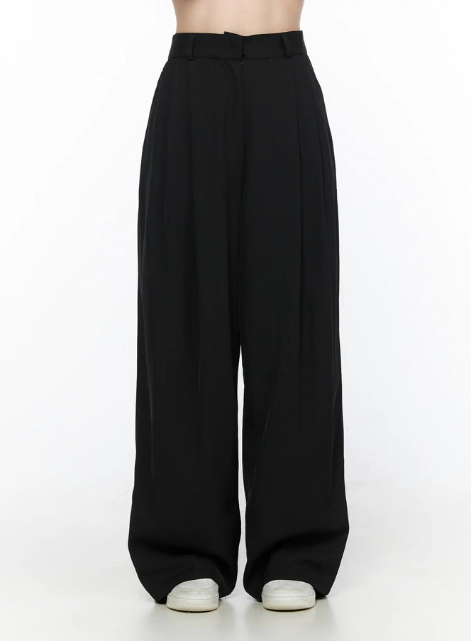 Pintuck Wide Leg Pants (Black) CL524 Black front shot on model showing high waist belt loops and deep center pintuck pleats with wide leg silhouette