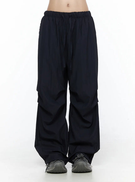 LEWKIN Pintuck Wide Leg Pants CL527 Dark blue front view on model wearing cropped tube top and sneakers, S/M, wide-leg silhouette with elastic drawstring waist