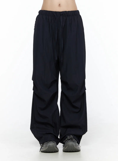 LEWKIN Pintuck Wide Leg Pants CL527 Dark blue front view on model wearing cropped tube top and sneakers, S/M, wide-leg silhouette with elastic drawstring waist