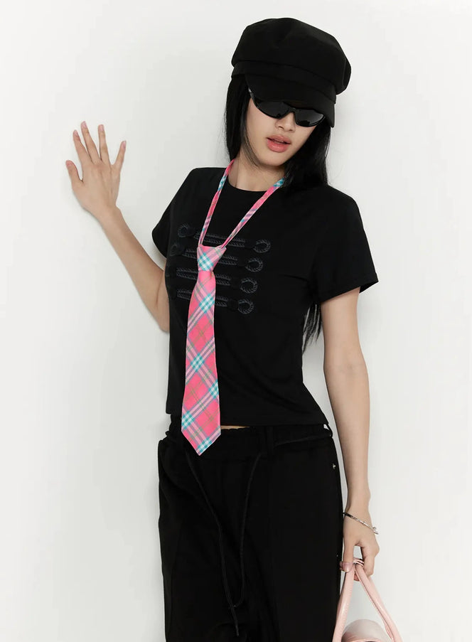 Plaid Adjustable Tie IL516 Pink front shot on model wearing black baker boy cap and sunglasses hand raised with pink teal plaid tie over black crop tee and black trousers