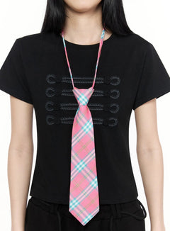 LEWKIN Plaid Adjustable Tie IL516 Pink One Size close-up on model torso showing pink teal plaid woven tie with pre-tied knot over black military embroidered tee