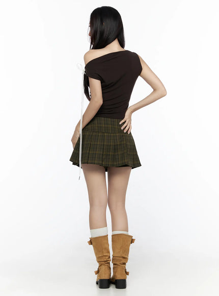 Plaid Button Pleated Mini Skirt CL524 green full-body back shot on model showing pleated back and skirt length styled with suede buckle boots