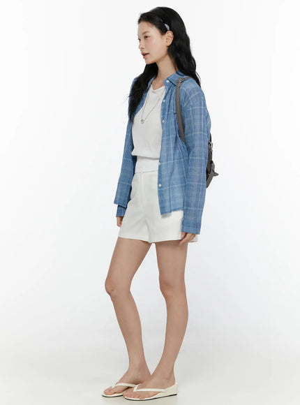 Plaid Button-Up Shirt CL521 Blue side shot on model showing full silhouette, open layered over white tee and shorts, gray backpack, relaxed oversized fit