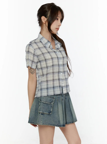 Plaid Crop Short Sleeve Shirt CL507 Light beige side shot on model with hair up looking left showing collar short sleeve and relaxed cropped fit over denim cargo skirt