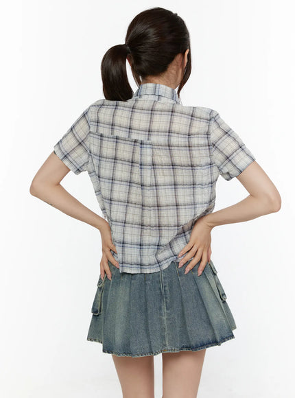 Plaid Crop Short Sleeve Shirt CL507 Light beige back shot on model hands on hips showing back seam cropped hem and blue navy plaid pattern with short sleeves