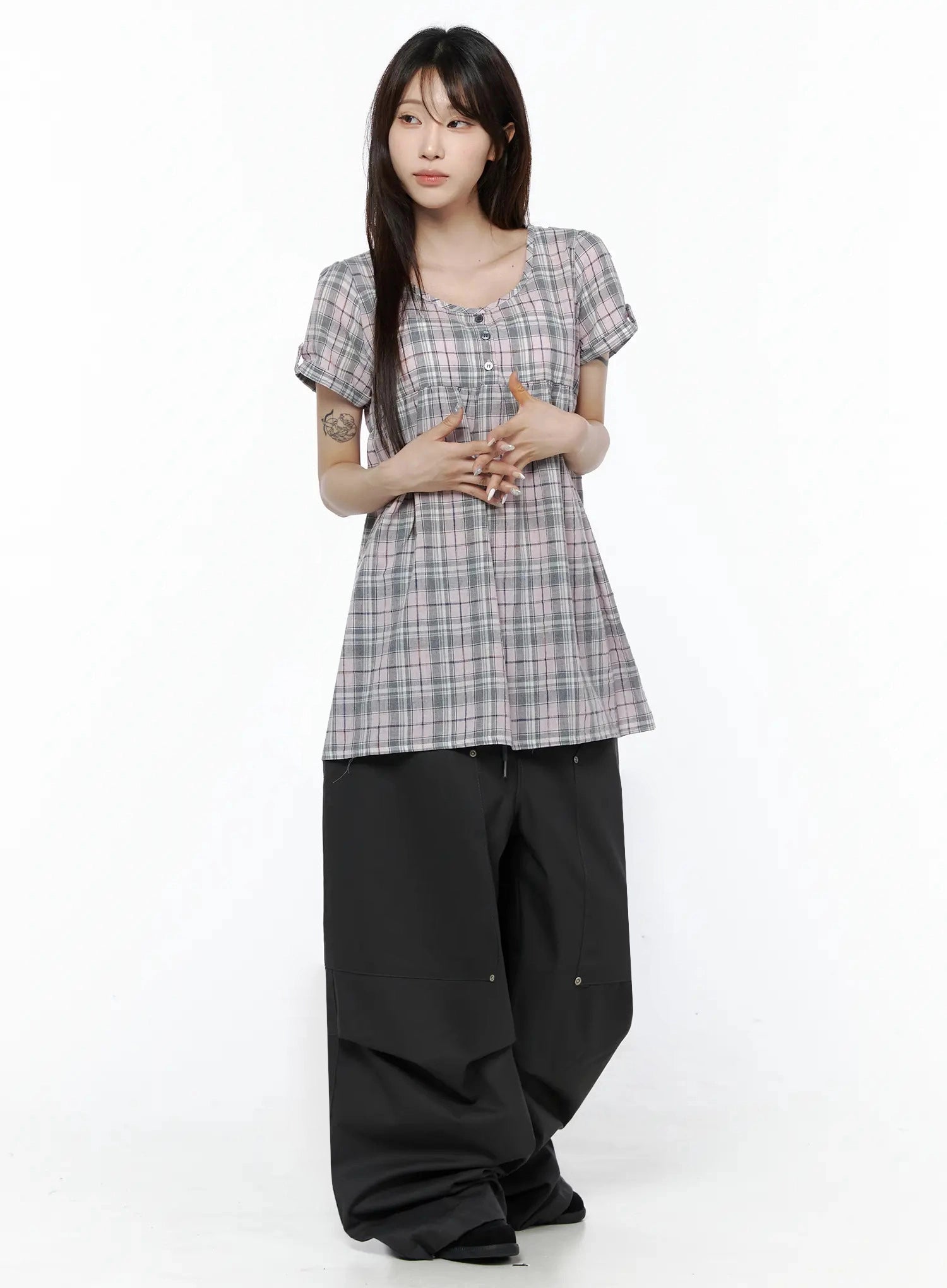 Plaid Cuffed Sleeve Babydoll Dress IL502 Pink full-body front shot on model with hands clasped at waist, styled with black wide-leg pants in clean studio setting