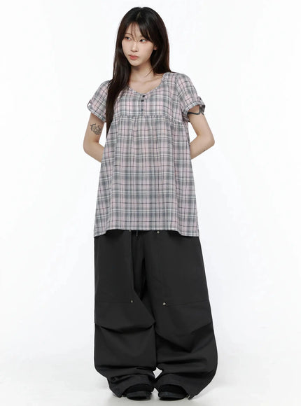 Plaid Cuffed Sleeve Babydoll Dress IL502 Pink full-body front shot on model with hands behind back, looking away, styled with black wide-leg cargo pants