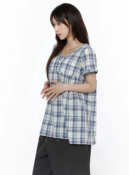 Plaid Cuffed Sleeve Babydoll Dress IL502 Blue side shot on model showing A-line silhouette, gathered empire waist, and cuffed short sleeves paired with black pants