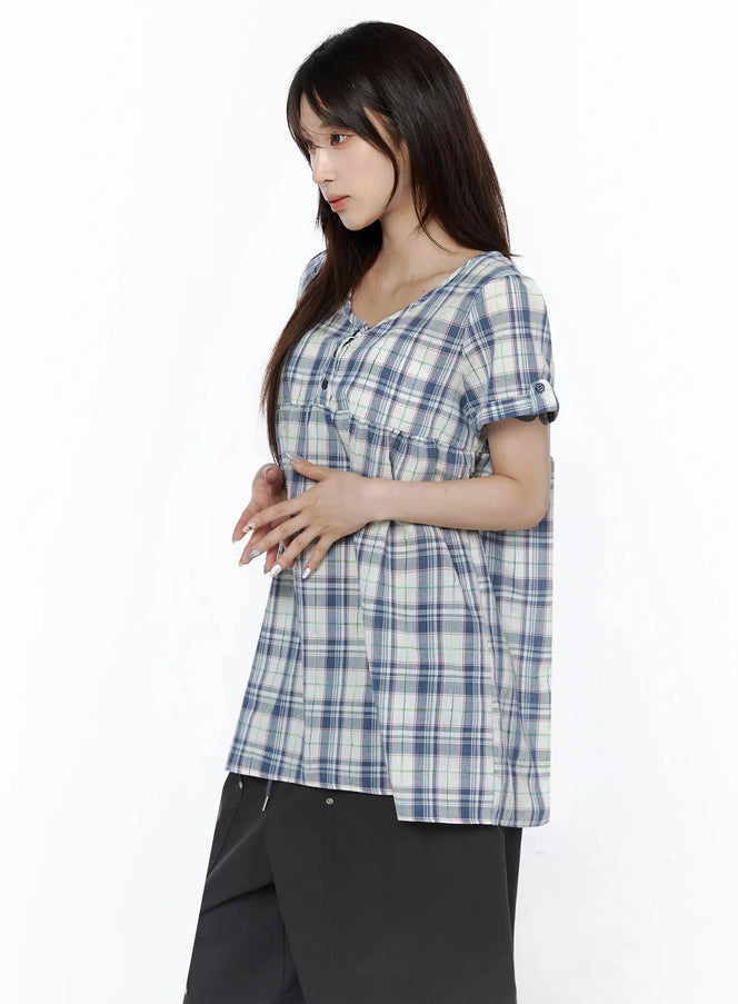 Plaid Cuffed Sleeve Babydoll Dress IL502 Blue side shot on model showing A-line silhouette, gathered empire waist, and cuffed short sleeves paired with black pants
