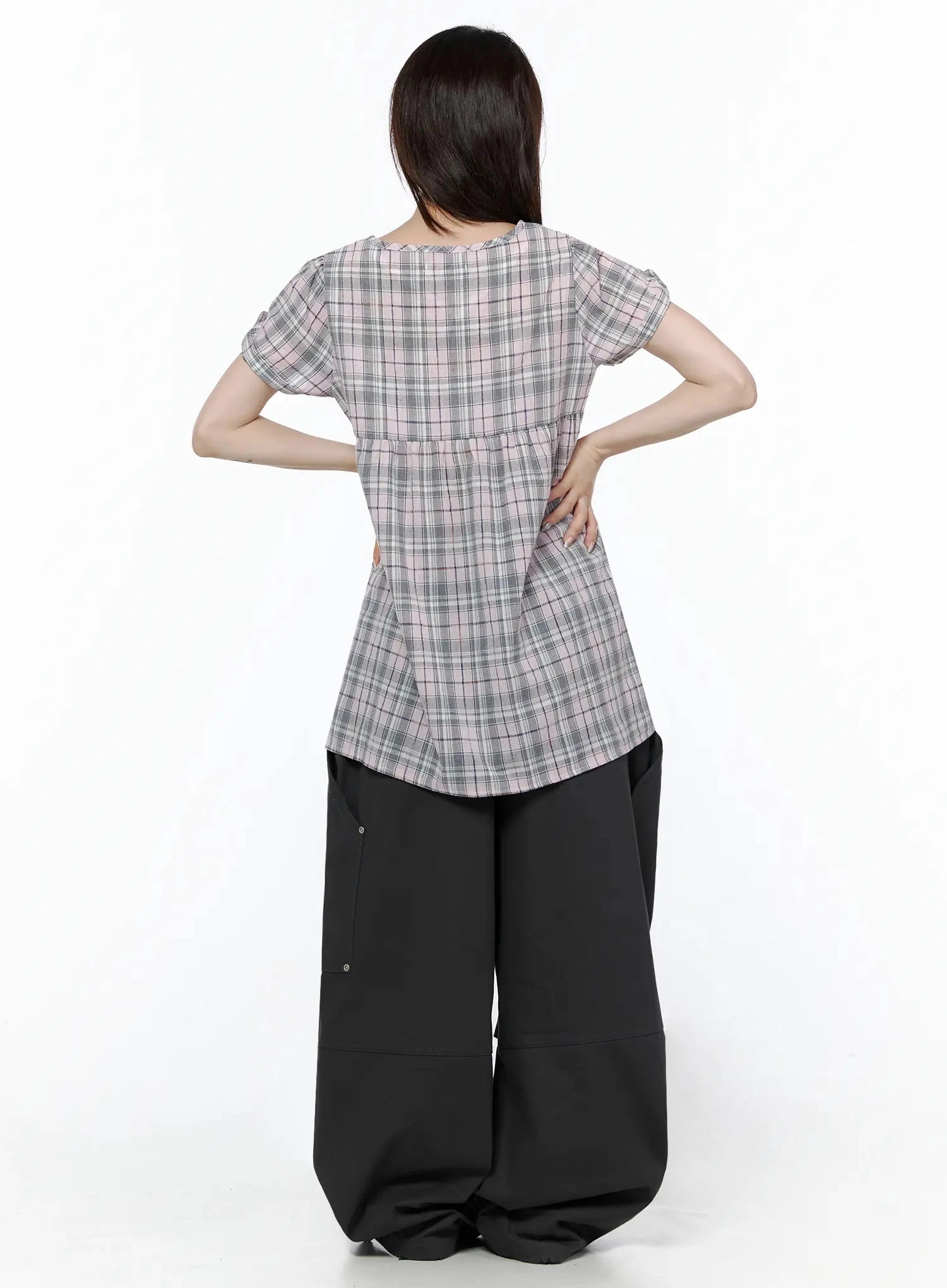 Plaid Cuffed Sleeve Babydoll Dress IL502 Pink back shot on model with hands on hips showing rear silhouette, gathered waist seam, and plaid pattern from behind