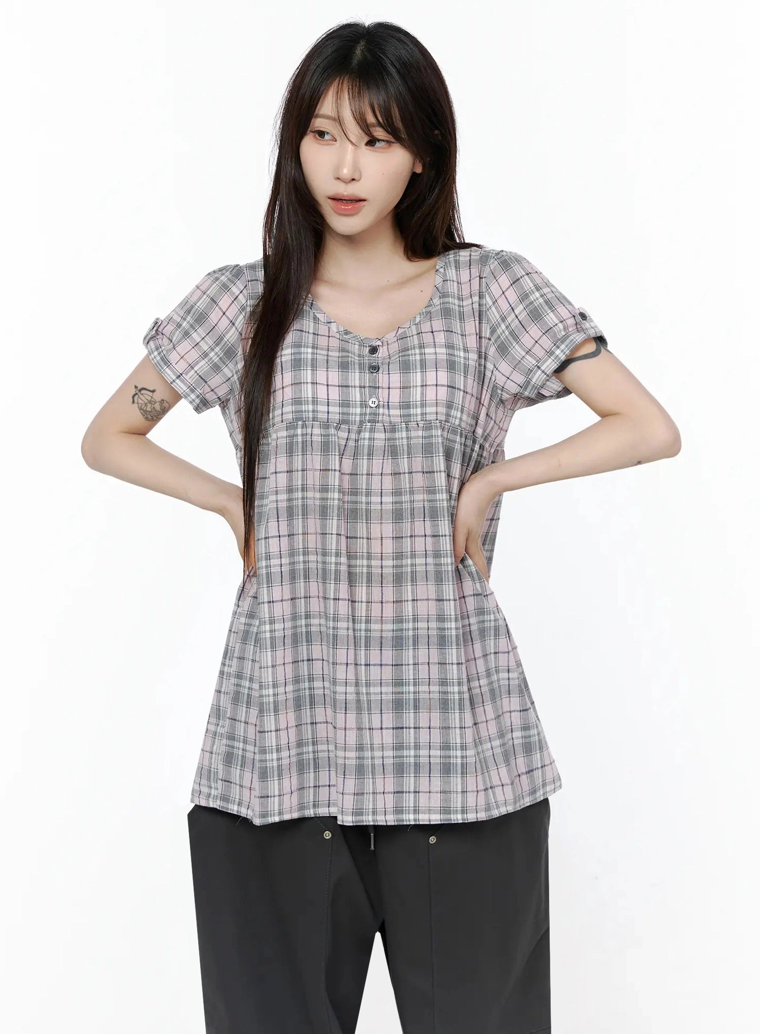 Plaid Cuffed Sleeve Babydoll Dress IL502 Pink front shot on model with hands on hips showing gathered empire waist, button placket, and rolled cuff sleeve detail