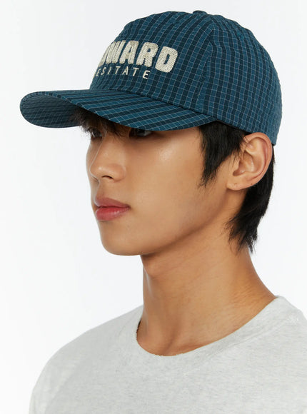 Plaid Embroidered Cap IL515 Dark blue side close-up on male model showing brim profile and orange adjustable cord detail at back