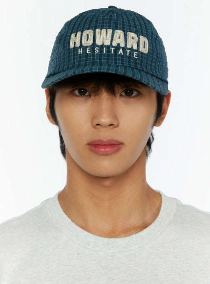 Plaid Embroidered Cap IL515 Dark blue three-quarter close-up on male model showing brim shape and embroidery at slight angle
