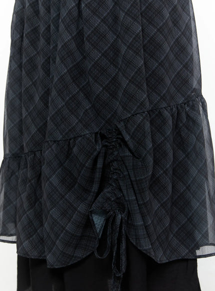 Plaid Layered Midi Skirt IL522 Black close-up detail shot showing ruched drawstring cinching on sheer plaid outer layer tiered ruffle hem and black underlayer fabric texture
