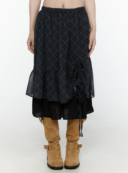 Plaid Layered Midi Skirt IL522 Black front shot on model cropped waist-down view without ruching gathered showing elastic waist sheer plaid overlay black underlayer tan boots