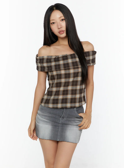 Plaid Off-Shoulder Shirt CU529 Brown front model shot with off-shoulder frill neckline paired with gray denim mini skirt standing pose