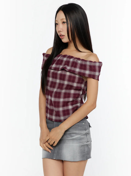 Plaid Off-Shoulder Shirt CU529 Red three-quarter side model shot showing ruched bodice and frill neckline detail paired with gray denim mini skirt