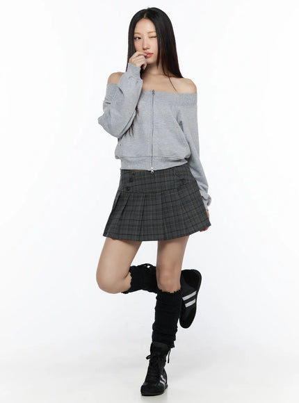 Plaid Pleated Mini Skirt CL527 Gray full-body front model shot styled with gray off-shoulder crop zip sweatshirt one leg raised showing pleated silhouette