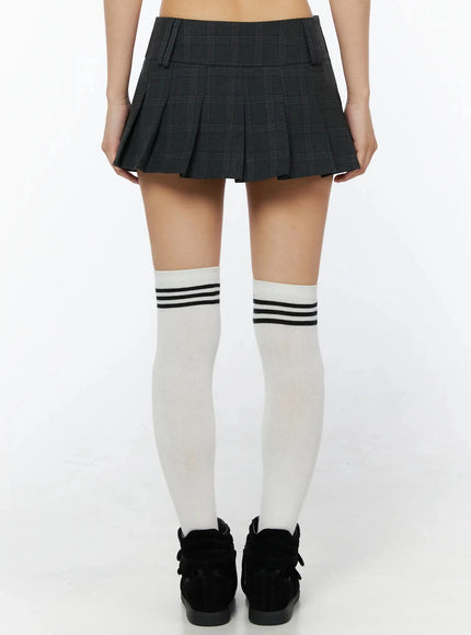 Plaid Pleated Mini Skirt IL516 Dark gray back shot on model showing rear pleats and waistband with white over-the-knee striped socks and black sneakers