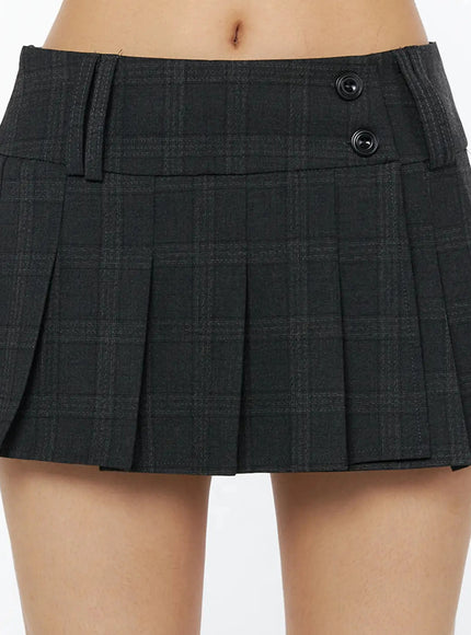 Plaid Pleated Mini Skirt IL516 Dark gray close-up detail shot showing double button waistband plaid fabric texture and knife pleats on model