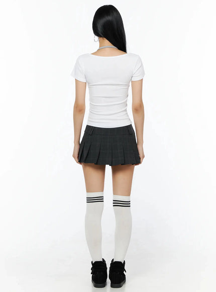 Plaid Pleated Mini Skirt IL516 Dark gray full-body back shot on model showing rear waistband and pleats with white t-shirt and white knee-high socks