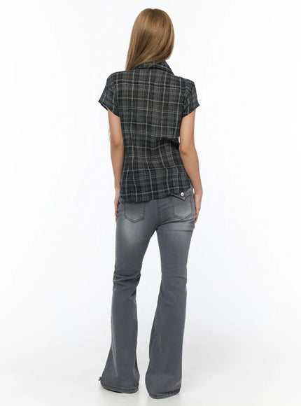 Plaid Shirred Blouse CU524 black back model shot showing plaid texture short cap sleeves and relaxed hem with gray flare jeans