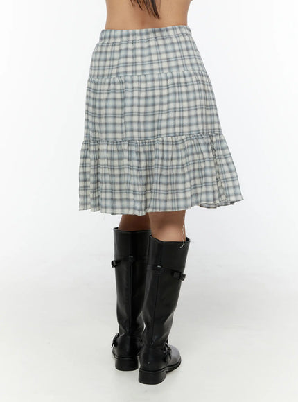 Plaid Tiered Midi Skirt CU529 Light blue back view on model showing tiered skirt silhouette and flared ruffle hem styled with black knee-high boots
