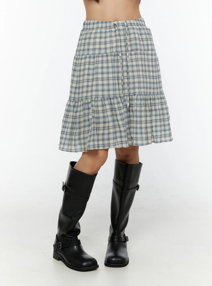 Plaid Tiered Midi Skirt CU529 Light blue side close-up on model showing elastic drawstring waist and tiered ruffle hem with black knee-high boots