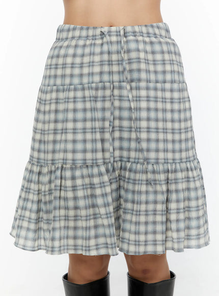 Plaid Tiered Midi Skirt CU529 Light blue front close-up on model showing drawstring elastic waistband detail and tiered plaid panels with ruffle hem
