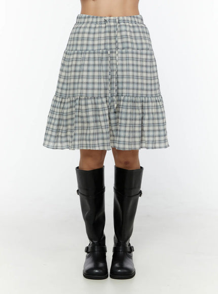 Plaid Tiered Midi Skirt CU529 Light blue front model shot cropped at waist highlighting elastic waistband tiered skirt body and full plaid pattern