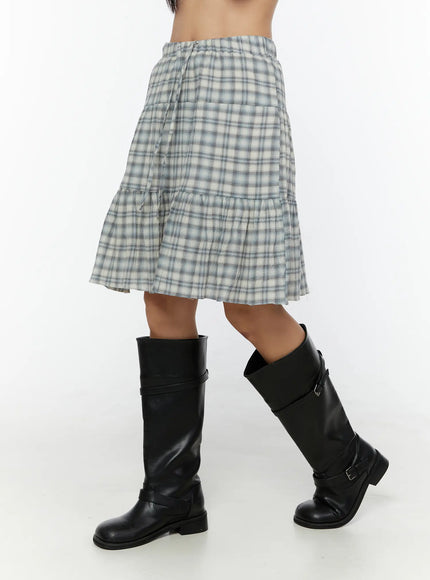 Plaid Tiered Midi Skirt CU529 Light blue opposite side view on model highlighting tiered gathered hem panels and lightweight woven plaid fabric