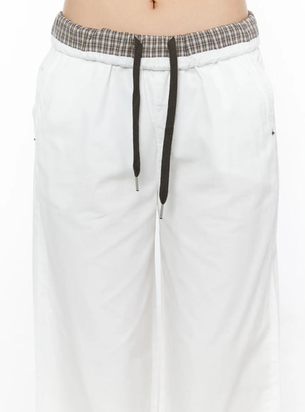 Plaid Waistband Wide-Leg Trousers CL502 White close-up detail shot of plaid contrast waistband dark drawstring with metal aglets and silver rivet