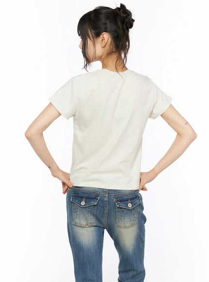 Playful Print Cropped T-Shirt CU530 cream back shot on model showing clean plain back short sleeves and cropped hem with jeans