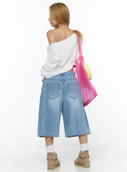 Pleated Denim Jorts CL528 light blue back lifestyle shot on model styled with white off-shoulder top and pink mesh tote bag