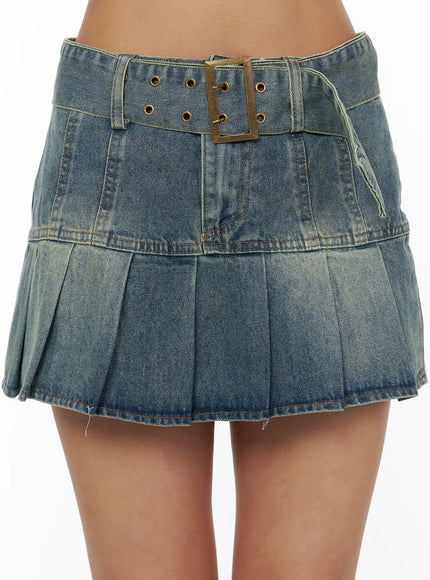 Pleated Denim Skirt CL503 Blue close-up detail shot on model showing antique brass square buckle belt and vintage-washed denim texture