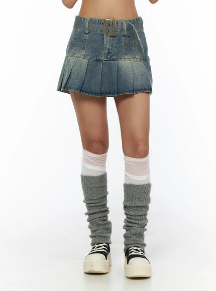 Pleated Denim Skirt CL503 Blue front close-up on model showing brass buckle belt and pleated hem with leg warmers