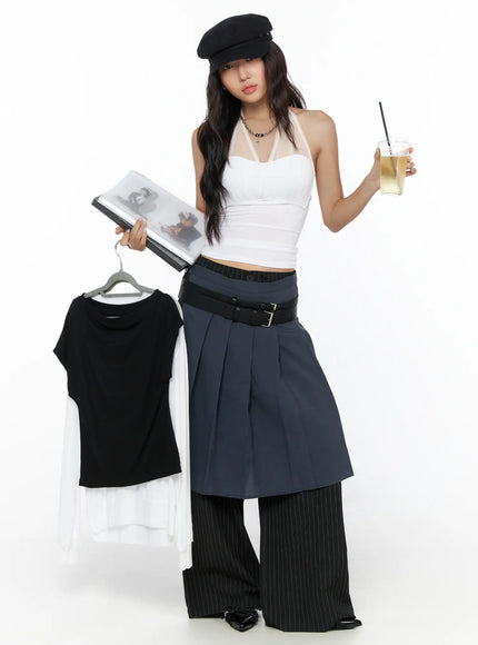 LEWKIN Pleated Midi Wrap Skirt CL513 navy blue editorial shot model holding hanger and drink wearing layered skirt over black pinstripe wide-leg pants with double belt