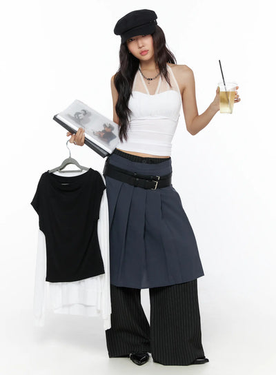 LEWKIN Pleated Midi Wrap Skirt CL513 navy blue editorial shot model holding hanger and drink wearing layered skirt over black pinstripe wide-leg pants with double belt