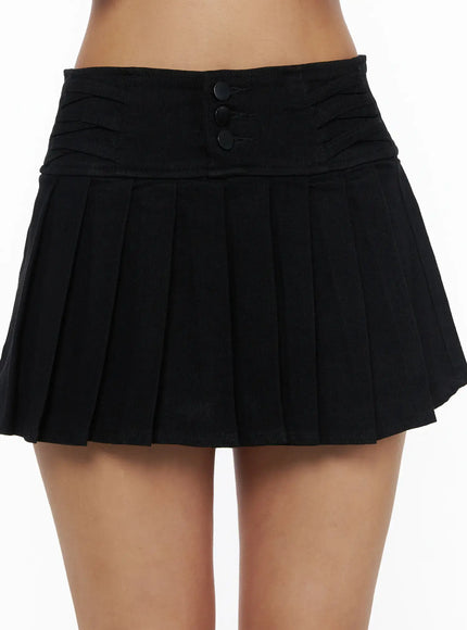 Pleated Mini Skirt CL503 Black close-up detail shot showing triple-button ruched waistband construction and deep knife pleats on model