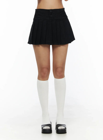 Pleated Mini Skirt CL503 Black front close-up on model showing triple-button ruched waistband and knife pleats with white knee socks